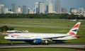 Tampa, FL, May 2022 - British Airways Boeing 777 taking off from Tampa International Airport with city of Tampa in the background