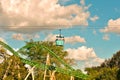 Couple enjoying Skyride attraction. Panoramic view of Cheetah Hunt and beatiful forest on blue