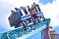 Riders with happy faces and panic faces in amazing Cobra`s Curse Rollercoaster at Bush Gardens