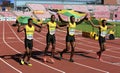 Jamaican 4x100 relay team running with flags after winning silver on the IAAF World U20 Championship in Royalty Free Stock Photo