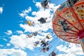 Tampere, Finland - 24 June 2019: Ride Swing Carousel in motion in amusement park Sarkanniemi on blue sky background