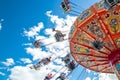 Tampere, Finland - 24 June 2019: Ride Swing Carousel in motion in amusement park Sarkanniemi on blue sky background