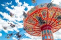 Tampere, Finland - 24 June 2019: Ride Swing Carousel in motion in amusement park Sarkanniemi on blue sky background