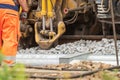 Detailed view of a tamping machine at work