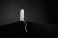 Tampon on dark table background. Female daily Intimate hygiene. Menstruation products for women gynecological health. Close up