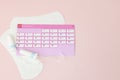 Tampon, feminine, sanitary pads for critical days, feminine calendar, pain pills during menstruation on a pink background. Royalty Free Stock Photo