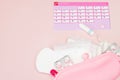 Tampon, feminine, sanitary pads for critical days, feminine calendar, pain pills during menstruation on a pink background. Royalty Free Stock Photo