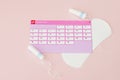 Tampon, feminine, sanitary pads for critical days, feminine calendar, pain pills during menstruation on a pink background. Royalty Free Stock Photo