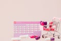 Tampon, feminine, sanitary pads for critical days, feminine calendar, pain pills during menstruation on a pink background. Royalty Free Stock Photo