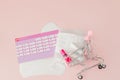 Tampon, feminine, sanitary pads for critical days, feminine calendar, pain pills during menstruation on a pink background. Royalty Free Stock Photo