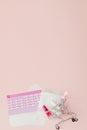 Tampon, feminine, sanitary pads for critical days, feminine calendar, pain pills during menstruation on a pink background. Royalty Free Stock Photo