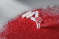 Tampons with red glitters on grey background Royalty Free Stock Photo