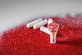 Tampons with red glitters on grey background Royalty Free Stock Photo