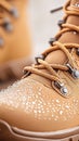 Tan Boot Detail With Water Droplets. Close view of boot laces and wet surface. Focus on drops. Second boot out of focus in Royalty Free Stock Photo