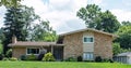 Tan Flagstone House with Various Shrub Landscaping