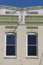 Tan and green brick building front with corrugated brick accents, vertical