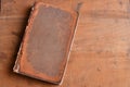 Tan vintage leather bound book laying on old rustic wood Royalty Free Stock Photo