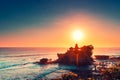 Tanah Lot Temple on the rock in Sea. Ancient hinduism place of worship. Sunlight. Aerial view. Bali, Indonesia Royalty Free Stock Photo