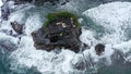 Tanah Lot Temple on the rock in Sea. Ancient hinduism place of worship. Sunlight. Aerial view. Bali, Indonesia Royalty Free Stock Photo