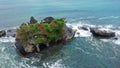 Tanah Lot Temple on the rock in Sea. Ancient hinduism place of worship. Sunlight. Aerial view. Bali, Indonesia Royalty Free Stock Photo