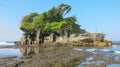 Tanah Lot water temple in Bali during low tide with blue sky and waves. Famous Hindu temple main Bali landmark. Indonesia. Famous Royalty Free Stock Photo