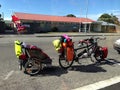 A tandem bicycle with a baby trailer