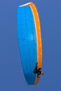 Tandem blue and orange paragliding flight