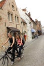 Tandem cycling on old Bruges street Belgium