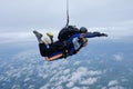 Tandem skydiving in the cloudy sky. Royalty Free Stock Photo