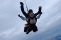 Tandem skydiving in the cloudy sky. Royalty Free Stock Photo