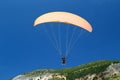 Tandem orange paragliding against a blue sky, sunny day Royalty Free Stock Photo