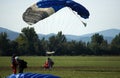 Tandem parachute jump at the moment of landing shot
