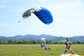 Tandem parachute jump at the moment of landing shot