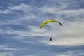 A tandem paraglider and high altitude clouds.