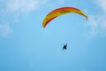 Tandem paragliders flying in the cloudy sky