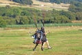 Paramotor pilot taking off from a field Royalty Free Stock Photo