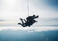 Two people skydiving together in a tandem jump with a parachute deployed Royalty Free Stock Photo