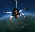 Tandem skydivers over earth
