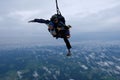 Tandem skydiving in the cloudy sky. Royalty Free Stock Photo