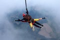 Skydiving. Tandem jump. Man and young woman are falling in the sky together.