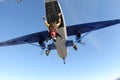 Skydiving. Tandem jump. Man and young woman are falling in the sky together.