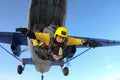 Tandem skydiving. SKydivers are jumping out of a plane.