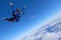 Tandem skydiving. Two guys are in the blue sky.