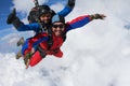 Skydiving. Tandem is flying in the clouds. Royalty Free Stock Photo
