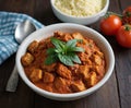 tandoori chicken with masala, ginger garlic cloves , cooked with garam and olive oil, bowl on the table with cherry tomatoes