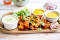 tandoori chicken party platter with dipping sauces Royalty Free Stock Photo