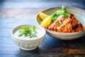 tandoori chicken served beside cucumber raita in a bowl Royalty Free Stock Photo