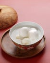 Tang Yuan, Chinese Glutinous Rice Dumpling Balls with Sugar Ginger or Palm Sugar Syrup on Red Chinese on Black Background for Royalty Free Stock Photo