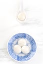 Tang yuan, tangyuan, yuanxiao in a small bowl stuffed with sesame fillings, top view, flat lay. Delicious asian food rice dumpling Royalty Free Stock Photo