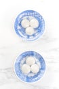 Tang yuan, tangyuan, yuanxiao in a small bowl stuffed with sesame fillings, top view, flat lay. Delicious asian food rice dumpling Royalty Free Stock Photo